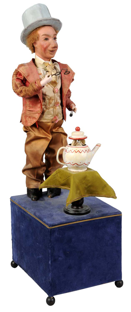 Renou automaton of 'Shrinking Magician,' 19½ inches tall, probably modeled after the Mad Hatter from Alice’s Adventures in Wonderland,1865. Papier-mache head, curly brown lambskin wig, bisque hands holding lorgnettes and wand. $8,000-$12,000. Dan Morphy Auctions image.