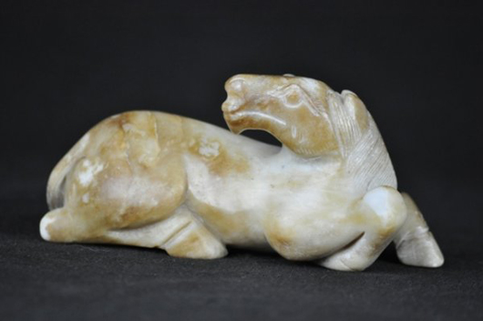 Celadon jade carving of a horse, Ming Dynasty, 5 inches long, estimate: $4,000-$5,000. Image courtesy of Wichita Auction Gallery.
