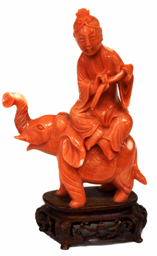 A Chinese carved red coral figure of a young beauty seated atop an elephant, 4¼ inches inclusive of stand, likely 19th century, realized $1,265. Austin Auction image.