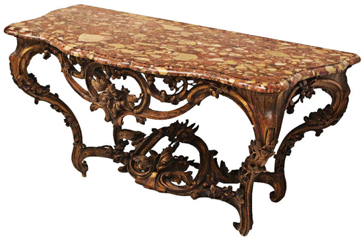 Carved in the Rococo taste with trails of flowering vines, an 18th-century, Louis XV marble-top console table features an opulent pierced and carved base. It sold for $8,625 against an estimate of $3,000-$5,000. Austin Auction image.