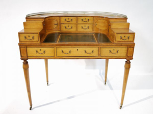 The curved superstructure of this George IV Carlton House desk is fitted with two tiers of drawers and topped with a brass gallery. Dating to the turn of the 19th century, the desk has a $20,000-$25,000 estimate. Image courtesy of Morton Kuehnert Auctioneers & Appraisers.