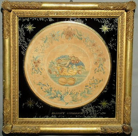 The artist signed her name in gilt on this reverse-painted watercolor painting of a basket of fruit and a dove with a floral border. Mounted in an ornate gilt frame, the early watercolor measures 25 inches by 24 inches overall and has a $4,500-$5,000 estimate. Image courtesy of Wiederseim Associates Inc.