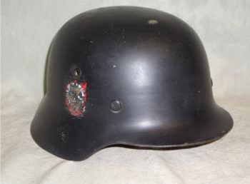 This is a Nazi M40 model double decal black helmet is fully leather lined for heavy combat. It has been ‘de-Nazified’ with both decals scratched out. It carries a $600-$925 estimate. Image courtesy of Universal Live.