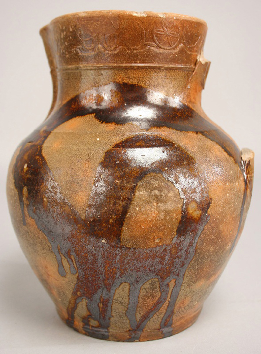 Tennessee redware pitcher by Christopher Alexander Haun (Greene County, 1821-1861). It is the only marked Haun pitcher form known. 8 1/4 inches high. Est. $3,500-$4,500. Image courtesy of Case Antiques Auctions and Appraisals.