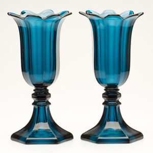 An outstanding pair of pressed Sandwich Tulip vase raised on rare hexagonal bases, brilliant deep peacock blue. Boston & Sandwich Glass Co., 1845-1865. Height: 11 inches. Estimate: $8,000-$12,000. Image courtesy Jeffrey S. Evans & Associates.