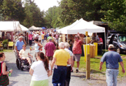 Visitors enjoy the open-air country atmosphere at Round Lake Antiques festival. Image courtesy of Allman Promotions.