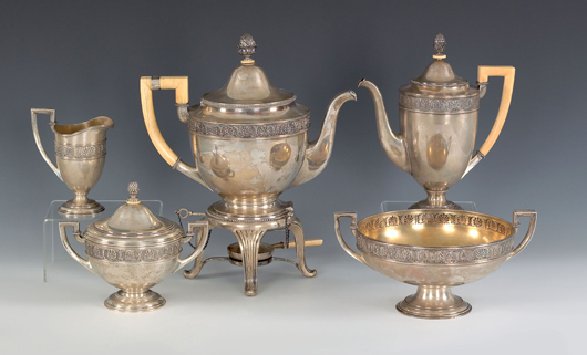 Russian five piece silver tea service, stamped in cyrillic {K. Faberge}, in the French Empire style to include a hot water kettle, 13 1/4" h., teapot, waste bowl, covered sugar, and creamer, 152.9 ozt. $64,350