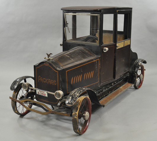 Circa-1924 American National Packard coupe pedal car with wicker-style door panels and eagle hood ornament, $43,700. Bertoia Auctions image.