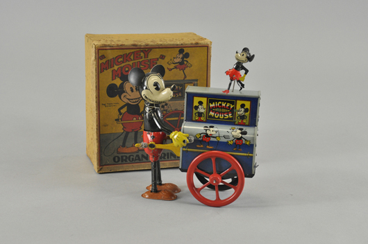 Boxed circa-1932 Distler (German) tinplate wind-up toy of Mickey Mouse Organ Grinder with dancing miniature Minnie, $19,550. Bertoia Auctions image.