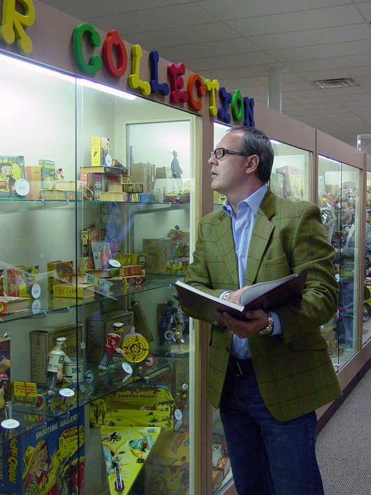 LiveAuctioneers' CEO, Julian R. Ellison, previews toys prior to the auction. Photo copyright Catherine Saunders-Watson.