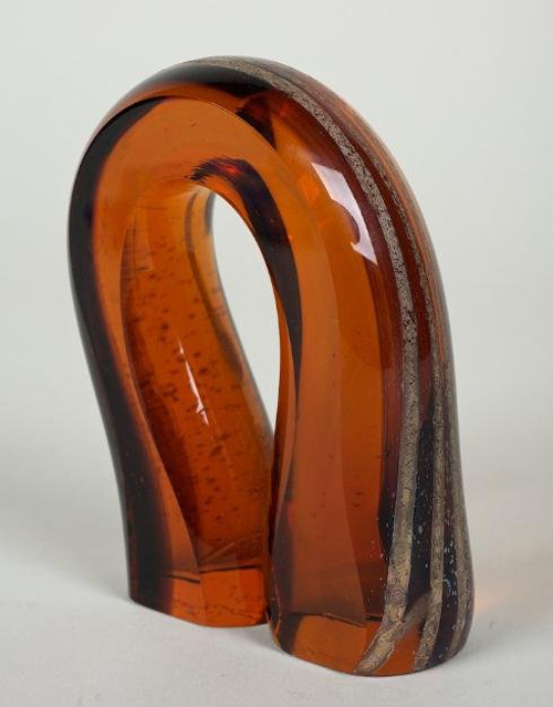 Glass sculpture by Harvey Littleton (born 1922, American), bent amber object, 1972, 5 inches high by 4 inches wide, estimate: $1,500-$2,500. Image courtesy of Millea Bros.