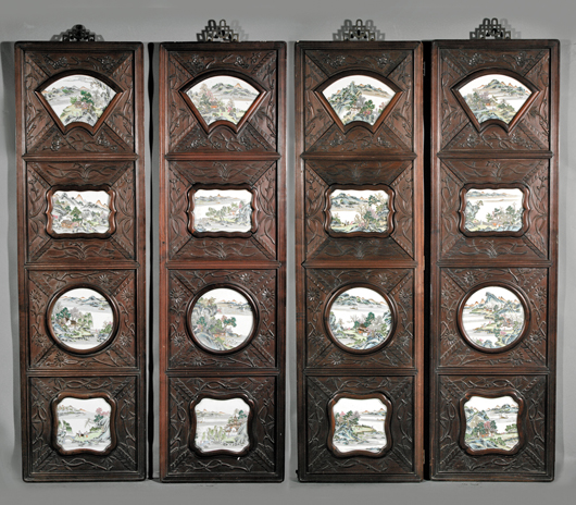 Famille Rose porcelain plaques are mounted on a set of four Chinese carved wood panels from the turn of the 20th century. Each panel is 61 inches high by 17 1/2 inches wide. They carry a $4,000-$6,000 estimate. Image courtesy Neal Auction Co.