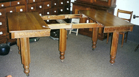 By the turn of the 20th century, the table needed extra support in the form of a fifth leg mounted to the slides.