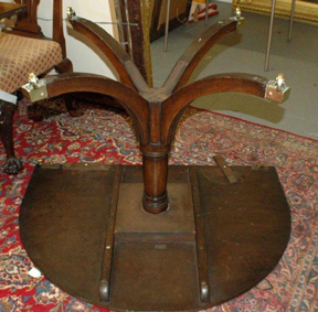 This shows the turn button wooden leaf supports under the table at the top edge of the photo.