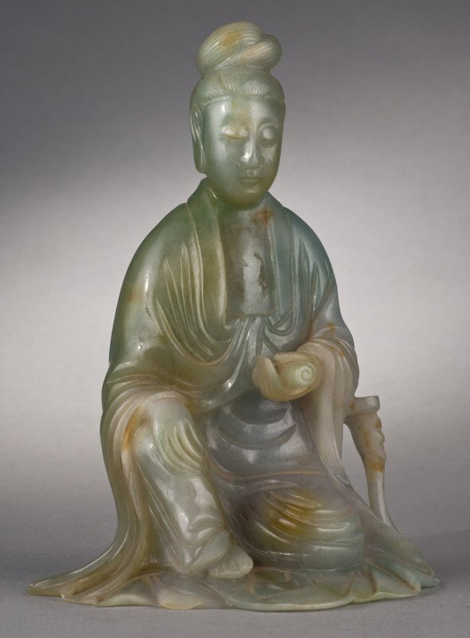 Bidding soared to $76,700 for this Chinese Qing carved jadeite seated Guanyin. Image courtesy of Dallas Auction Gallery.
