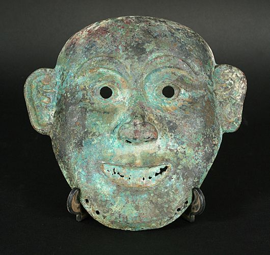 Bidders may be surprised by this Chinese Shang Dynasty bronze mask, which has a $500-$700 estimate. The 7 3/4-inch high face dates to the 16th-11th centuries B.C. Image courtesy of Kamelot Auctions.