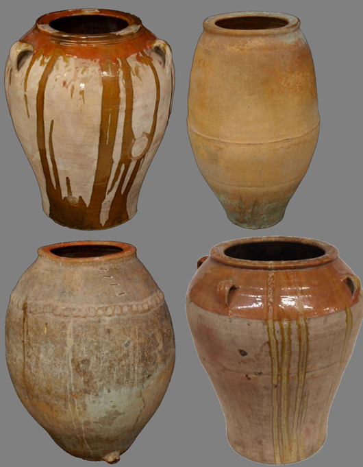 Four examples from a grouping of 30-40 antique earthenware olive jars acquired from northern Spain, each of substantial weight and standing 3½ feet tall. Austin Auction Gallery image.