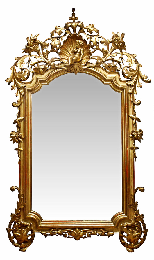 French 8½-foot-tall gold leaf mirror with a carved putto and wolves’ heads. Austin Auction Gallery image.