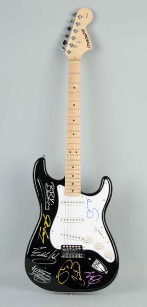 Black Fender "8 Legends of the Guitar" Stratocaster electric guitar. Signatures include: Jeff Beck, Keith Richards, Eric Clapton, B.B. King, Sting, Carlos Santana, Jimmy Page and Eddie Van Halen. Signed in gold, silver, yellow, blue and pink. Includes COA's from The Legacy Collection and N.A.S. and an appraisal from Schwartz & Sons Appraisals. A tamper-proof hologram matching the one accompanying the included certificate has been permanently attached to the guitar to verify its authenticity. Estimate $6,000-$10,000. Dan Morphy Auctions image.