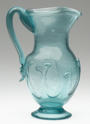Free-blown and lily-pad decorated tall pitcher, blue green, circa 1850-1890, Mackle Collection, $14,950. Image courtesy Jeffrey S. Evans & Associates.