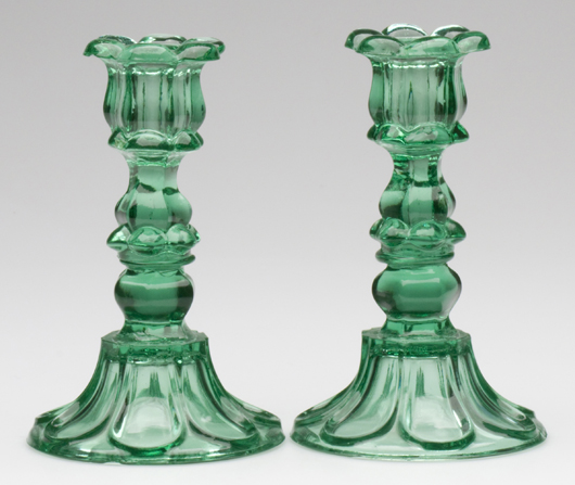 Pair of pressed Petal and Loop candlesticks in apple green, circa 1840-1860, Mackle Collection, $4,887.50. Image courtesy Jeffrey S. Evans & Associates.