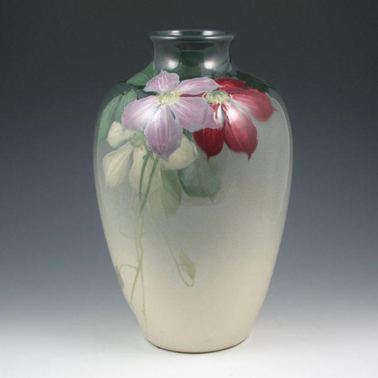 Signed ‘McLaughlin,’ this impressive Weller Eocean vase with life-like clematis decoration is in mint condition. The 13-inch-tall vase has a $1,200-$1,600 estimate. Image courtesy of Belhorn Auction Service.