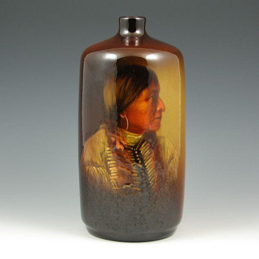 Decorator Mae Timberlake initialed this excellent Owens Utopian portrait vase depicting an American Indian. With a few light abrasions to the glaze on the back, the 10 5/8-inch vase has an $1,800-$2,400 estimate. Image courtesy of Belhorn Auction Service.