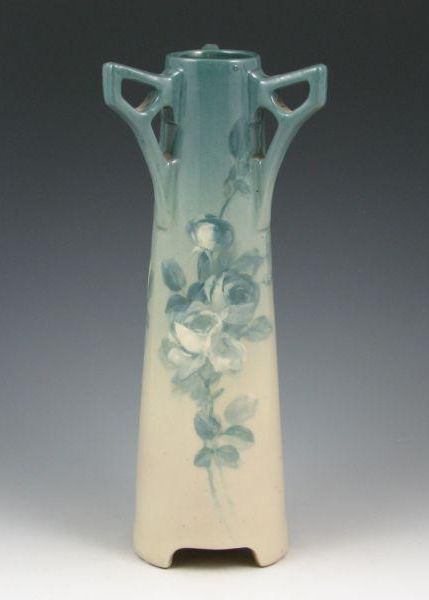 Three arm-like handles top this unusual Roseville Rozane (Light) vase, which has expertly decorated roses in slate blue and white on a background of the same slate blue fading to cream. The 12 1/4-inch vase has a $1,000-$1,400 estimate. Image courtesy of Belhorn Auction Service.