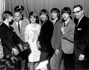 Ringo Starr accepting the gold snare drum in 1964 from William F. Ludwig, Jr., president of Ludwig Drum Company (second from left), as his daughter Brooke, Ludwig's director of marketing R. L. Schory (far right), and the other Beatles (John Lennon, George Harrison, and Paul McCartney) look on. Photo: Ludwig Industries.