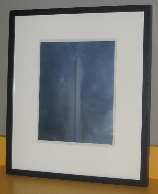 ‘Lake Geneva’ by Anthony Costifas, photograph of the ‘Jet d’ Eau’ in Lake Geneva against a stormy afternoon sky, size: 11 inches by 14 inches, edition: 1 of 10, estimate: $3,500-$3,600. Image courtesy of Bailey House.