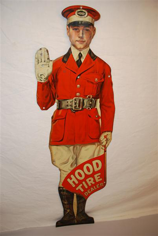 Hood Tire Man single-sided tin die-cut sign, 36 inches tall by 13 inches wide, rated 8.9/10. Image courtesy Matthews Auctions.