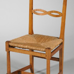 Val-Kill Industries cherry and maple ribbon-back armchair No. 57 with woven rush seat, branded mark and impressed mark "57J, FRANK." Estimate $300-$500. Image courtesy LiveAuctioneers.com and Skinner Inc.