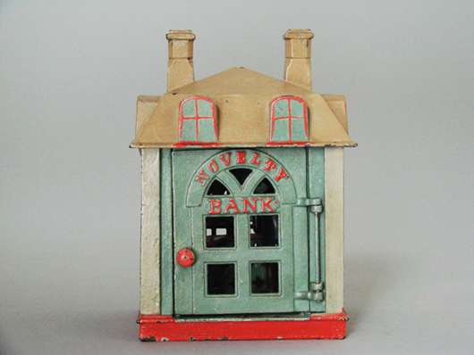 Only known example of J. & E. Stevens’ cast-iron mechanical "Novelty" bank in a seafoam green, cream, tan and red color motif, $29,160. RSL Auction image.
