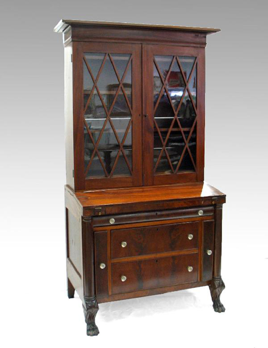This circa 1830 Empire two-piece secretary desk features a folding writing surface above one long drawer over two drawers, which are flanked by letter drawers. It carries an $800-$1,500 estimate. Image courtesy of Stephenson’s Auctioneers & Appraisers.