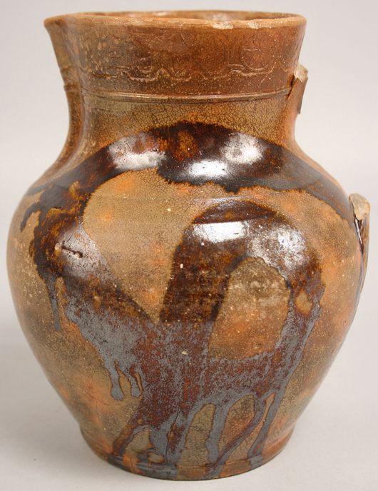 This simple pitcher with lead glaze enhanced by loops of manganese or copper oxide surpassed its estimate to reach $9,988. The rare form was marked by Christopher Alexander Haun, a Greene County, Tenn., potter who was executed in 1861 for being a Union sympathizer. Image courtesy Case Auctions, Knoxville, Tenn.