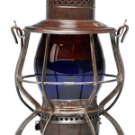 Rare 10-inch dual-color Pennsylvania Railroad lantern with cobalt blue glass bottom and ruby red glass shade. Embossed "PRR" and "Keystone Lantern Company Philadelphia PA USA" on top. Patent date December 30, 1907 and June 2, 1903. Near mint; est. $4,000-$8,000. Dan Morphy Auctions image.