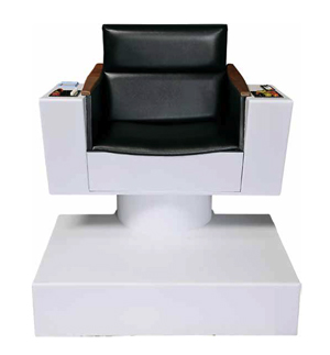The Original Series captains chair was used as the stand-in chair while filming the visual effects shots that placed Dax and Sisko on the bridge of Kirk's Enterprise in the 'Star Trek: Deep Space Nine' episode 'Trials and Tribble-ations.' Included in this lot is a Star Trek original series bridge rail piece. The lot has a $10,000-$20,000 estimate. Image courtesy of Propworx.