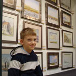 8-year-old Kieron Williamson is the talk of the art trade. He sells his work through Picturecraft Gallery & Exhibition Centre, where this picture was taken. Image copyright Picturecraft Gallery & Exhibition Centre.