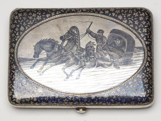 A Russian silver and niello cigarette case from the turn of the 20th century is decorated with a winter troika scene. Bearing a stamped city hallmark and Cyrillic letter maker’s mark, the case carries a $100-$200 estimate. Image courtesy of Jeffrey S. Evans & Associates.
