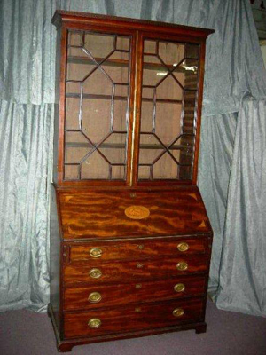 Two-piece, early 19th-century fall-front desk with bookcase top and inlaid conch in the drop. Image courtesy The Specialists of the South Inc.