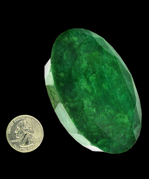 The length of the giant emerald is nearly four times the diameter of a U.S. quarter. The rare gem has been appraised for nearly a half-million dollars. Image courtesy of GovernmentAuction.com.