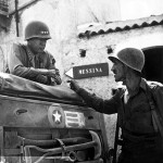 1943 photo of Gen. George S. Patton, left, discussing military strategy with Lt. Col. Lyle Bernard, commanding officer of the 30th Infantry Regiment, at Brolo, Sicily. National Archives & Records Administration Photo.