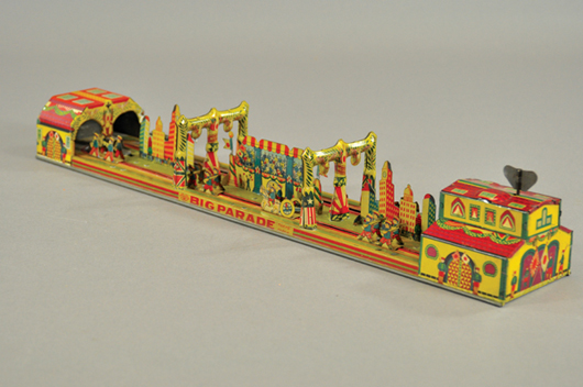 The Big Parade, Japan, circa 1930, lithographed tin wind-up toy with die-cut soldiers, autos, buildings and tunnel, $1,200-$1,500. Bertoia Auctions image.