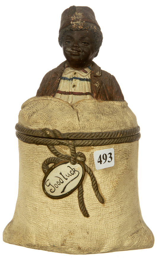 Rare 8-inch figural bisque black Americana humidor, with young boy and cotton bag graphic. Woody Auction image. 