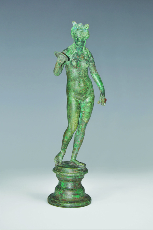 Molded, cast statuette of Aphrodite holding a mirror in one hand and a pomegranate in the other. Accompanied by multiple documents of provenance. TimeLine Auctions image.