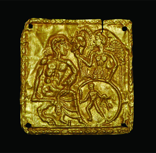 2nd century BC Greek gold applique depicting Nike presenting a Corinthian helmet to the god Pan. TimeLine Auctions image.
