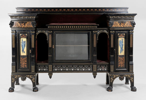 This 58¾ inch by 87¼ inch by 18¾ inch signed Herter Brothers cabinet with gilt and ebonized surfaces has a presale estimate of $15,000-$25,000. A cabinet with the same form but different ornamentation is illustrated in Herter Bros. Furniture and Interiors for a Gilded Age. Brunk Auctions image.