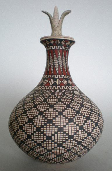 Mata Ortiz pottery vessel with lid, artist signed ‘Martha Marinez De Dominguez,’ white clay with black and rust design, very good condition, 10 1/2 inches high, est. $400-$600. Image courtesy of Rachel Davis Fine Arts.