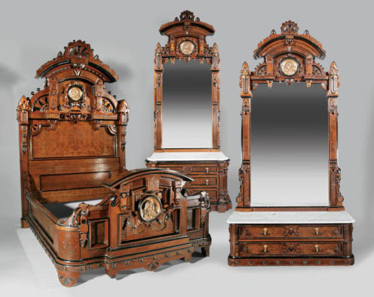 American Renaissance carved and ebonized walnut bedroom suite, late 19th century, attributed to Allen & Bro., Philadelphia, composed of two mirror-backed dressing chests and a monumental bedstead, est. $25,000-$35,000. Image courtesy of Neal Auction Co.