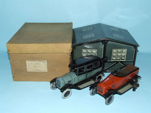 Bing (Germany) 1920s garage with two tinplate windup toy cars, original box. Estimate $2,000-$3,000. Image courtesy Toys of Times Past and LiveAuctioneers.com.